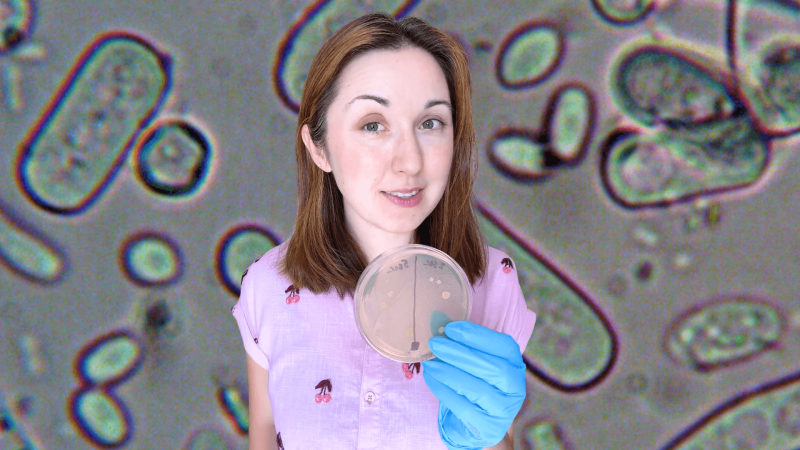 Alex Dainis holding an agar plate in front of a close up look at microbes.