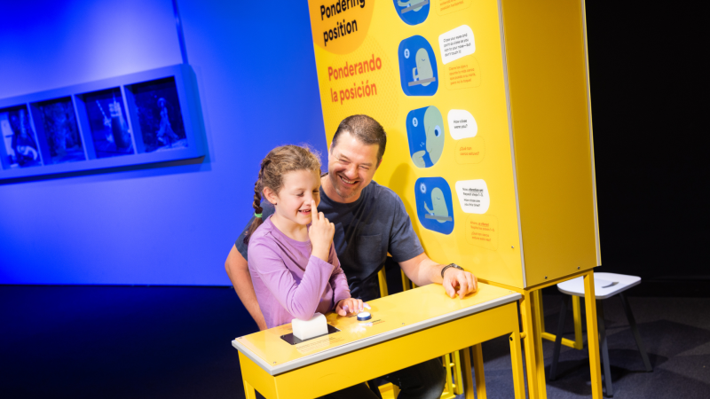 A father and daughter test out exhibit.