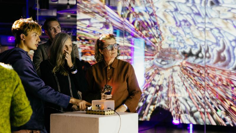 Guests interacting with projected artwork at Waveforms.