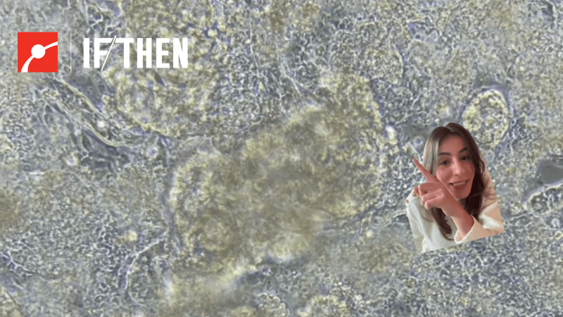 Marie in front of an image of heart cells beating in a petri dish.