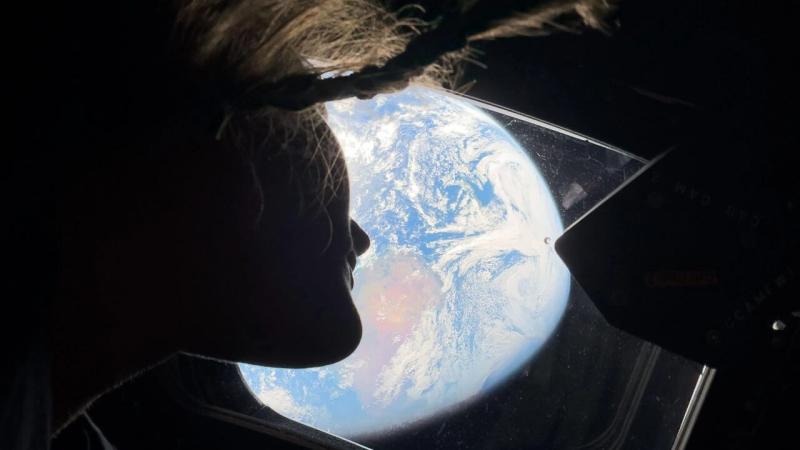 Astronaut Christina Koch looks out of the Orion capsule window towards Earth. Credit: NASA