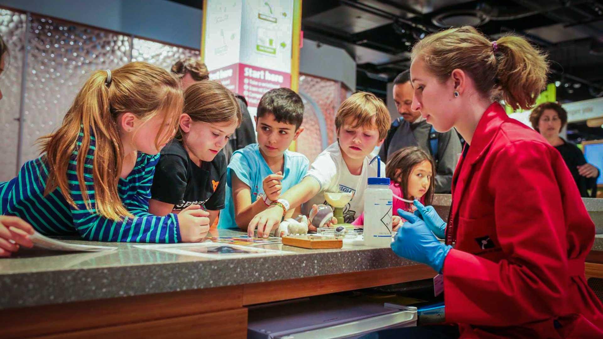 Children participating in an activity at the Biogen Exploration Hub.