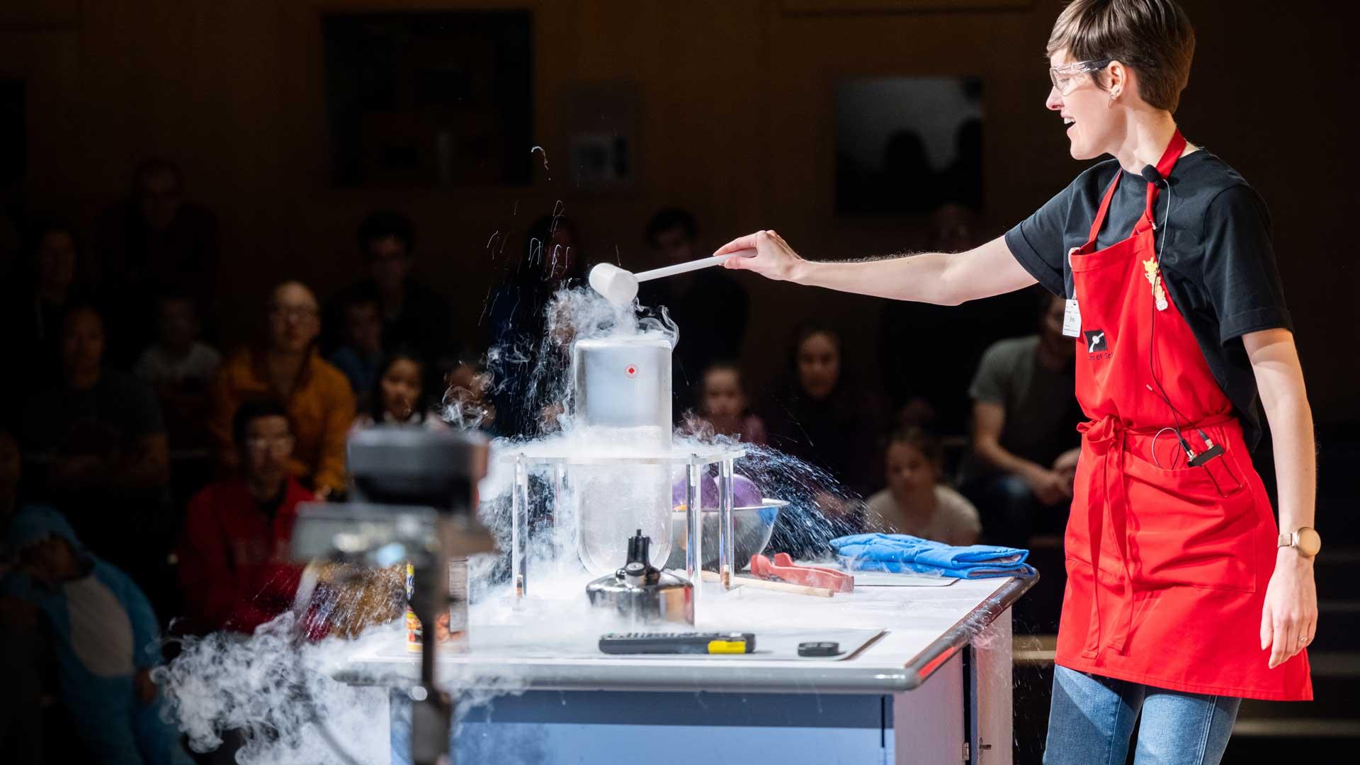 A museum eductaor conducting a science experiment with dry ice.
