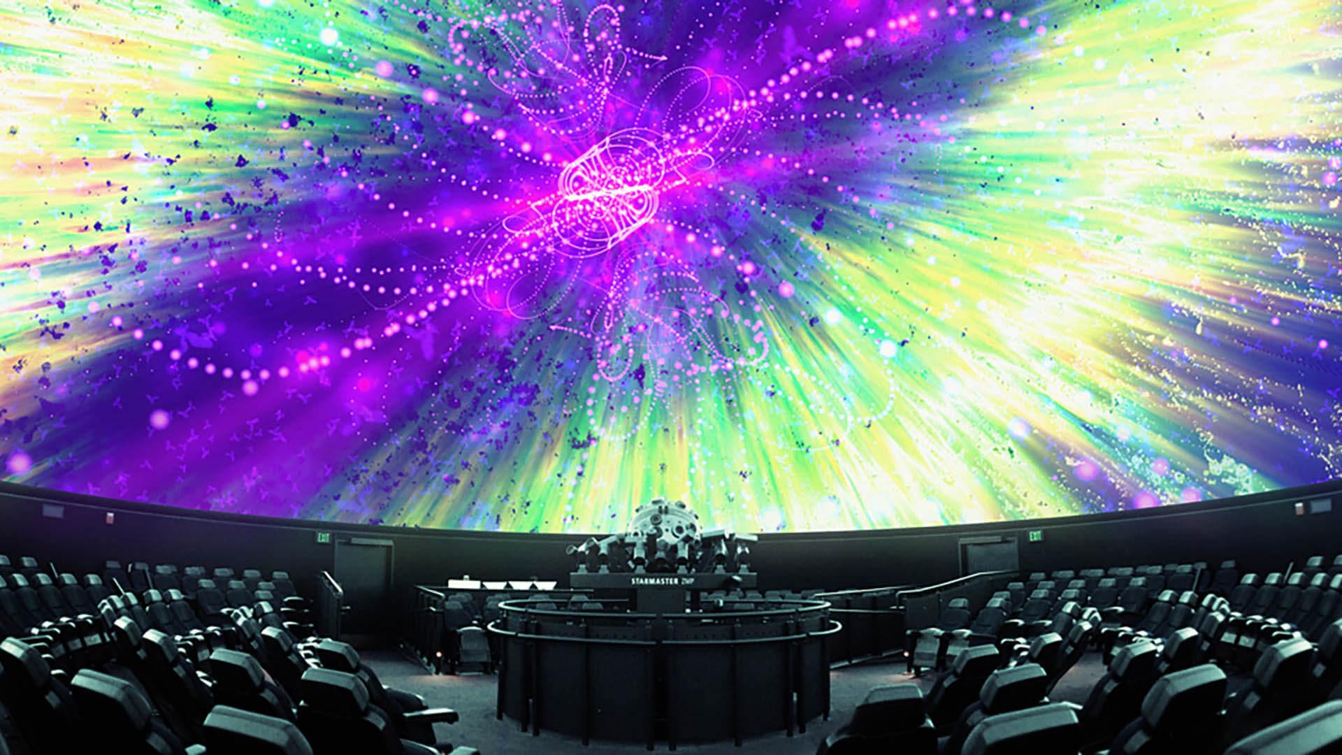 Colorful abstract shapes are projected on the planetarium dome.