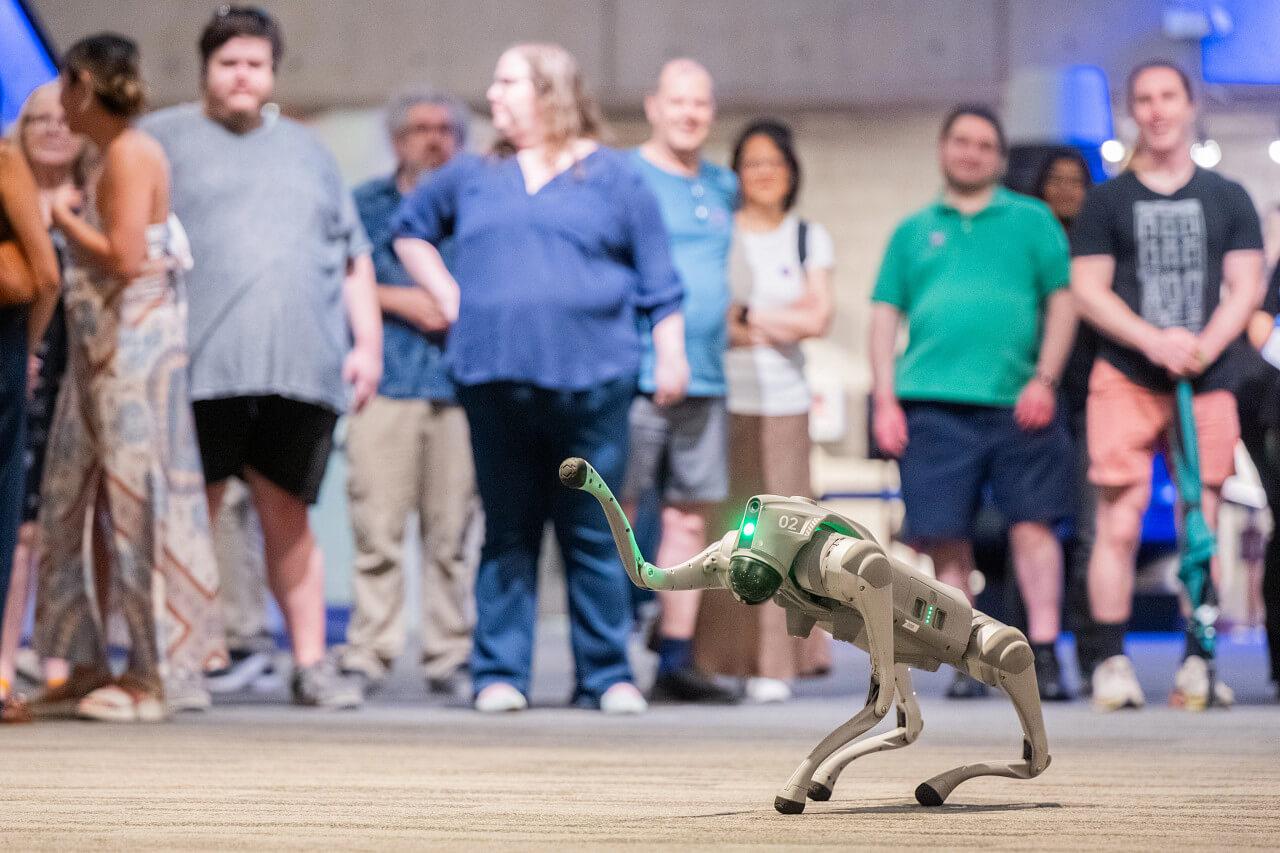 A robot waves to Museum visitors