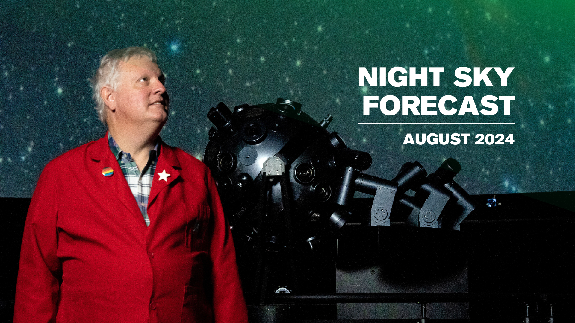 Planetarium Educator Chuck Wilcox standing by the Planetarium projector.