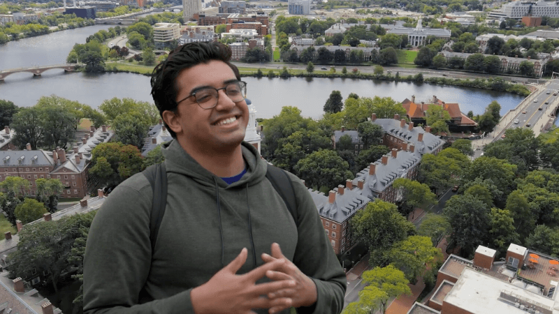 Siaam Khan in front of an overview of Harvard University