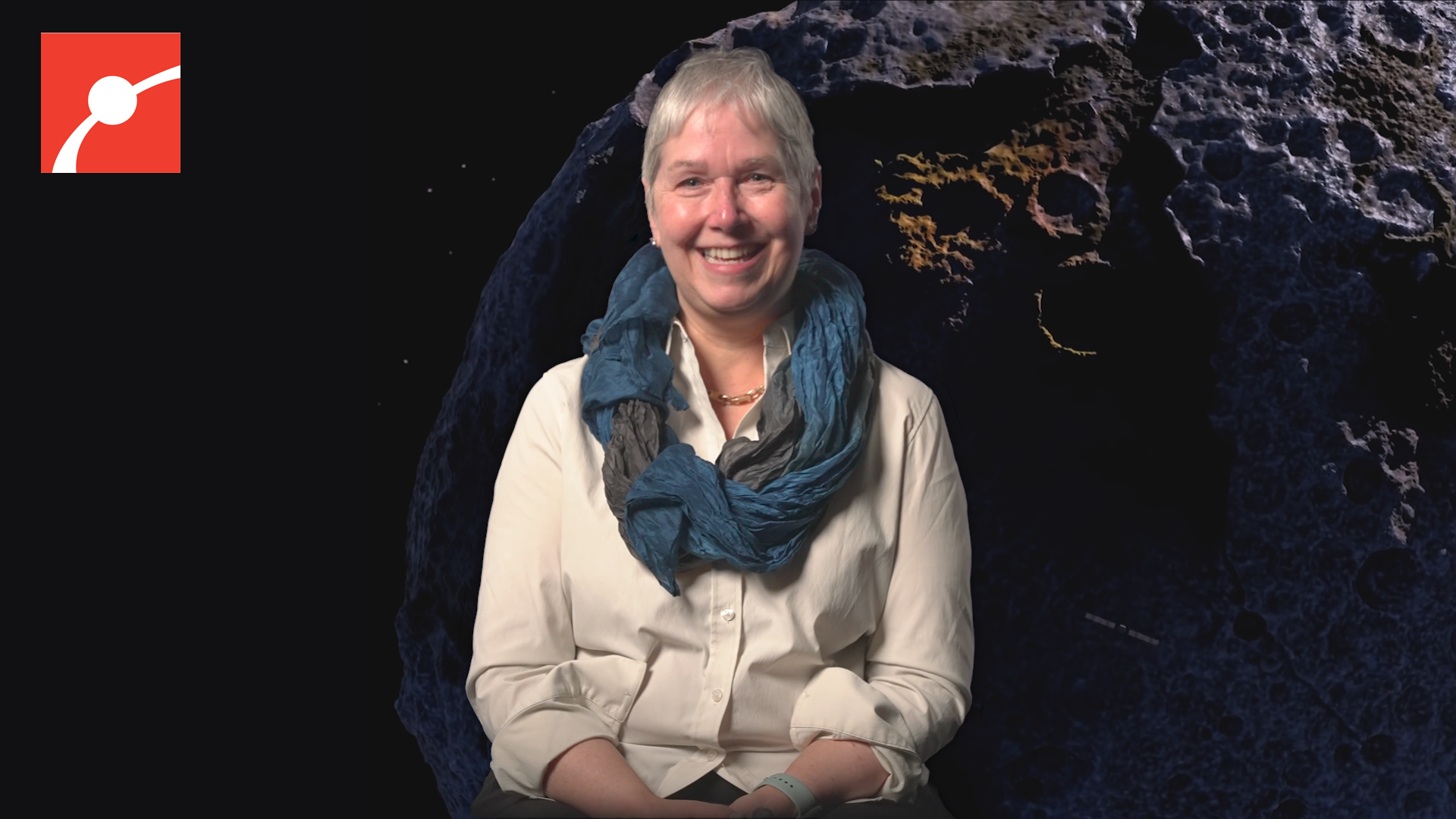 Lindy Elkins-Tanton smiling with asteroid behind her.
