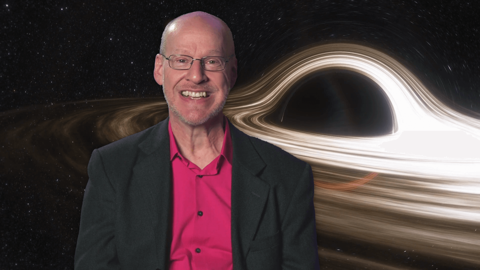 Phil Plait in front of an image of a black hole
