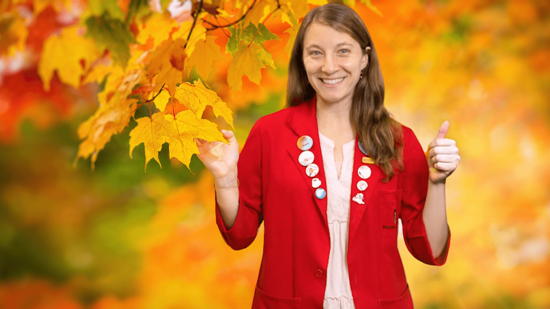 Museum Educator Sloane against a background of fall foliage
