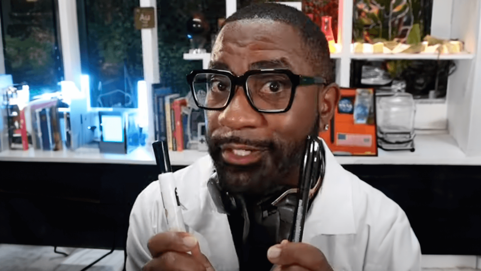 Maynard Okereke holding up a pen and dry erase marker