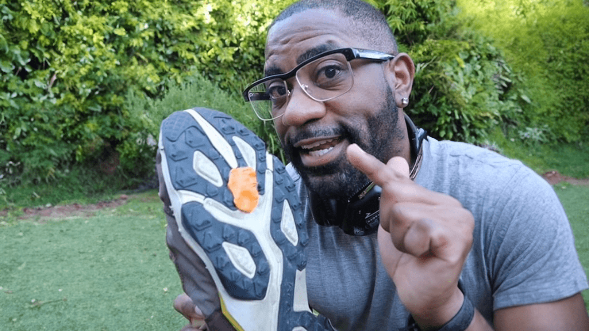 Maynard Okereke holding a sneaker with gum on the bottom