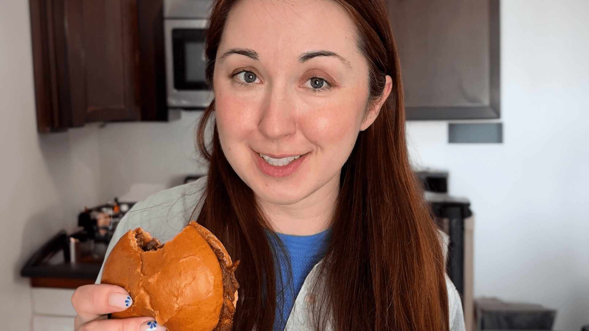 Alex Dainis holding a banana peel pulled pork sandwich