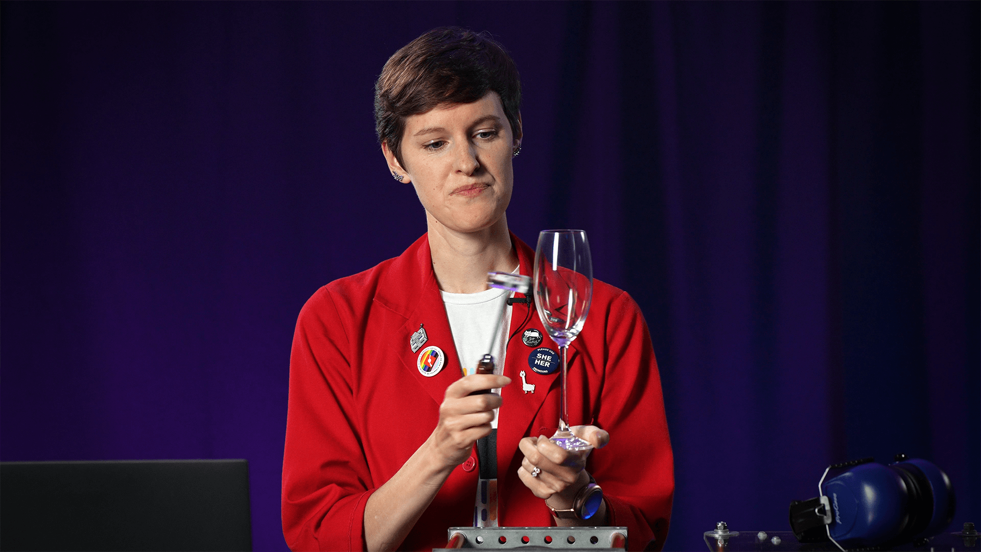 Emily holding a small mallet to a wine glass