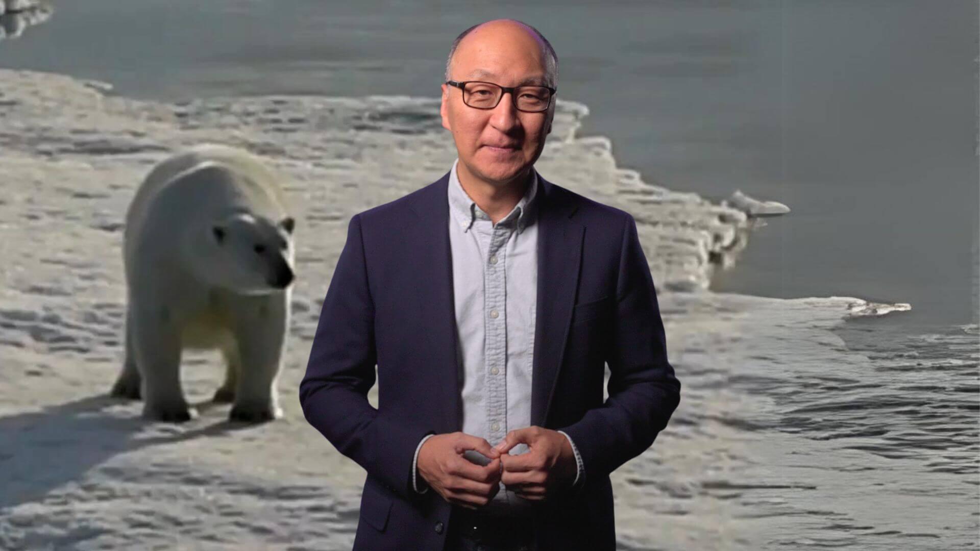 Insoo Hyun in front of an image of a polar bear
