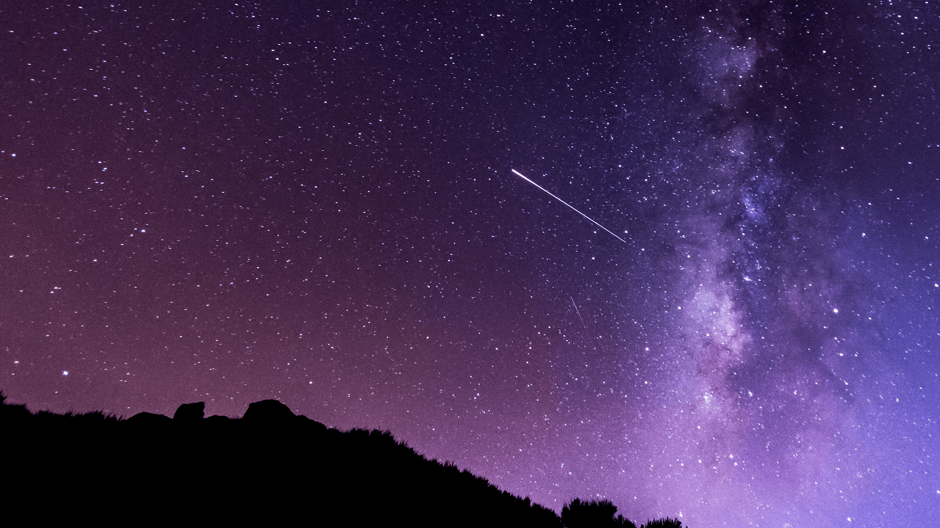 An Orionid meteor in a purple night sky
