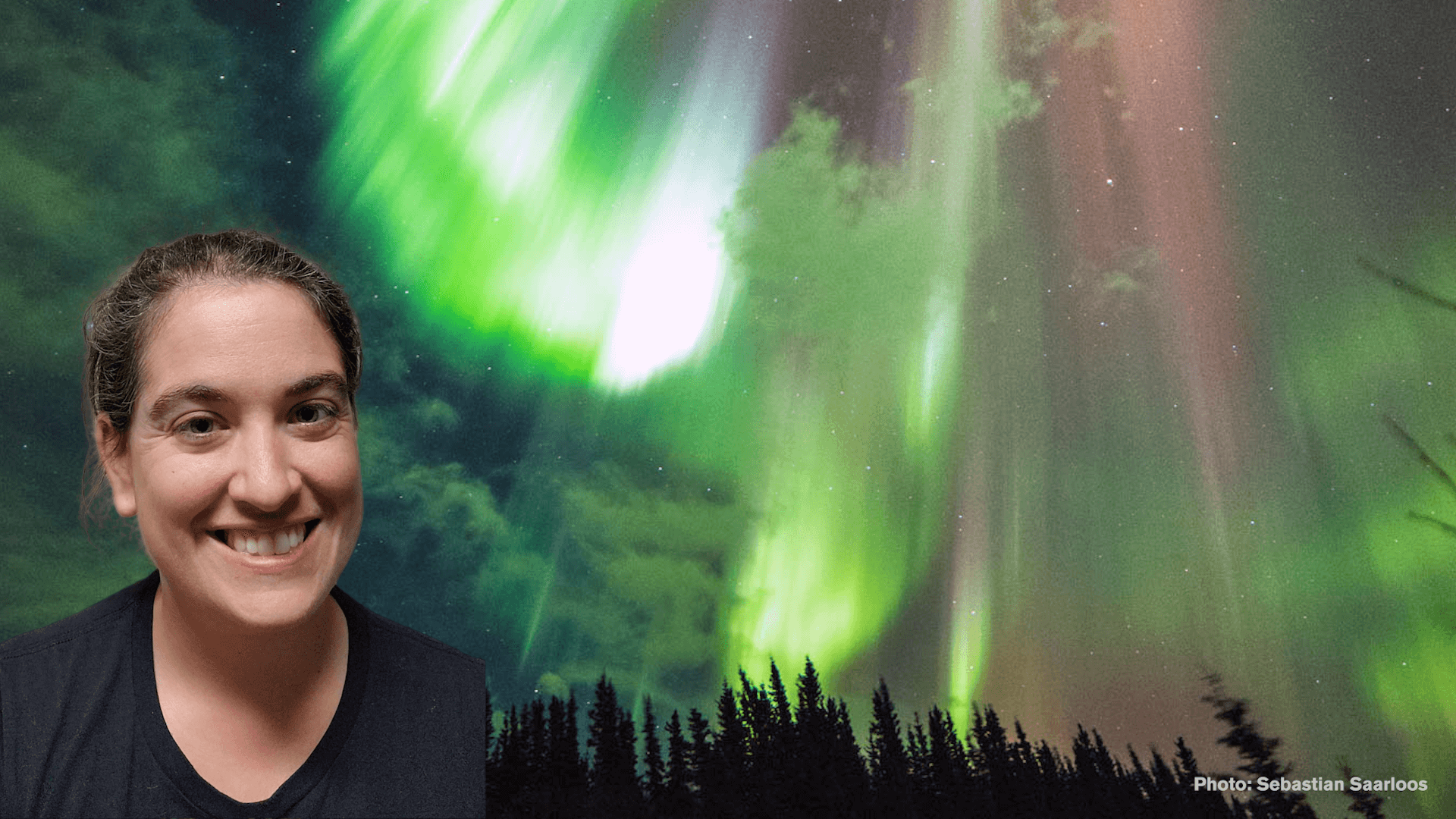 Talia in front of an image of the aurora