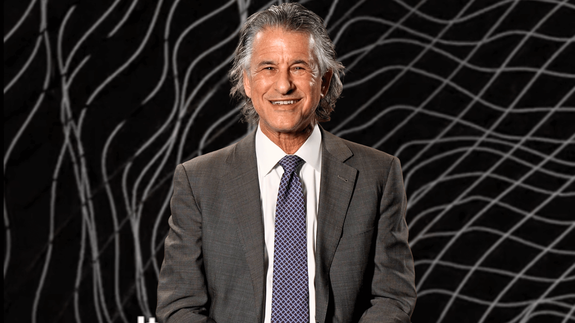Daniel Levitin in front of an image of sound waves