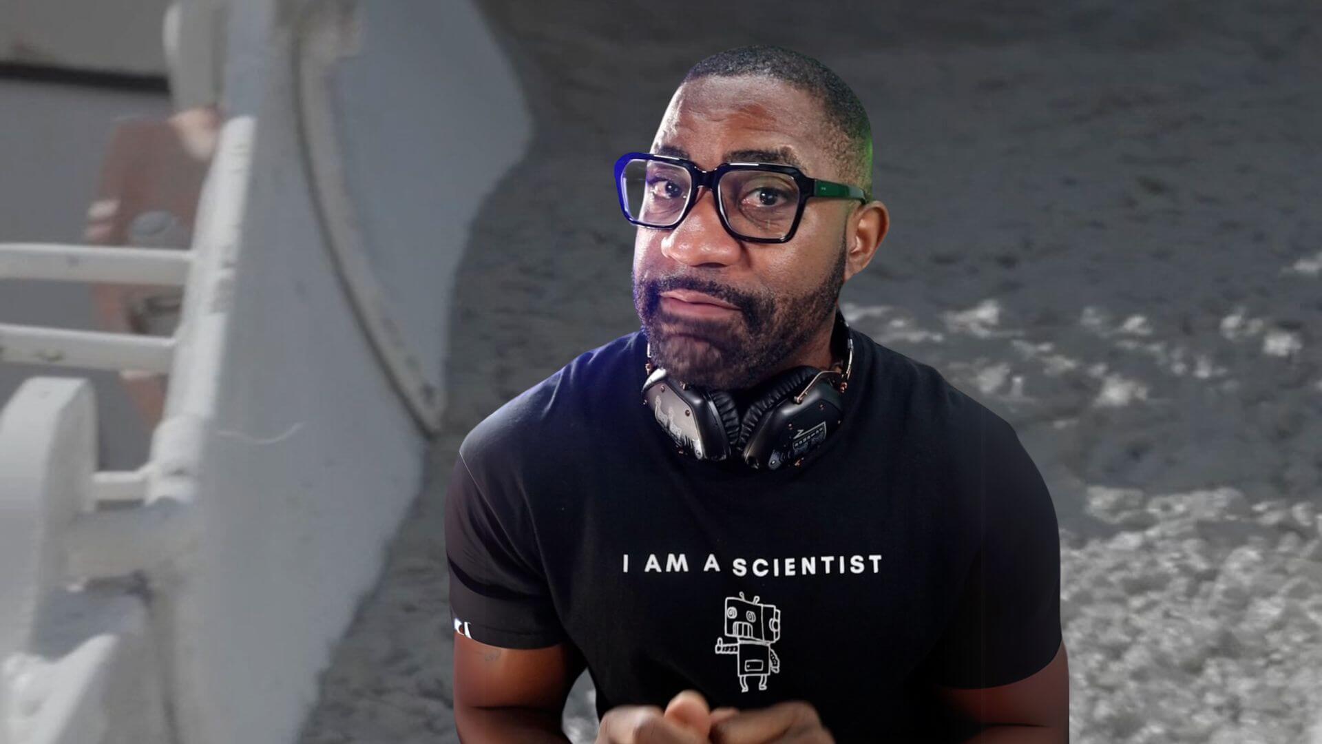 Maynard Okereke in front of an image of cement