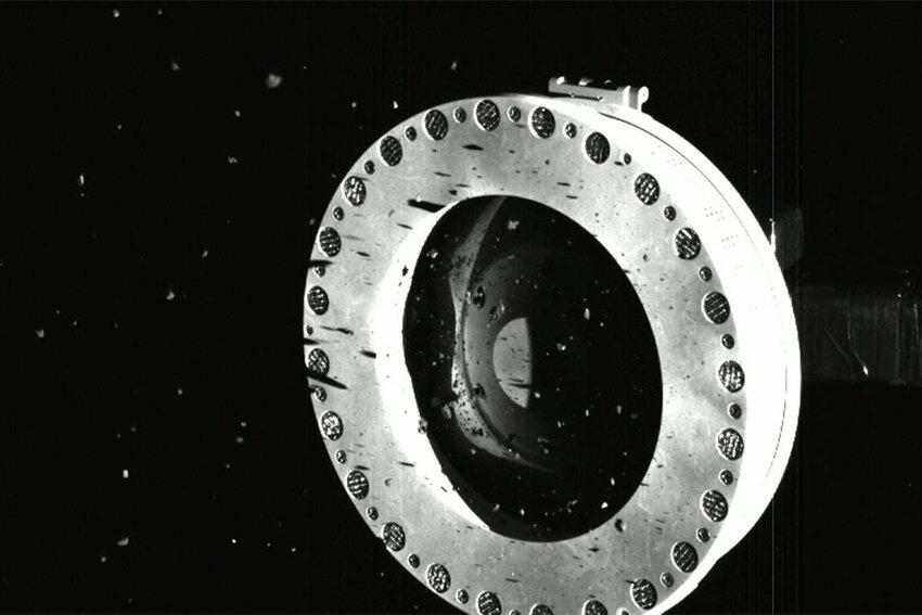 A view of OSIRIS-REx’s sample container with material coming loose because the cover could not close. Credit: NASA/Goddard/University of Arizona
