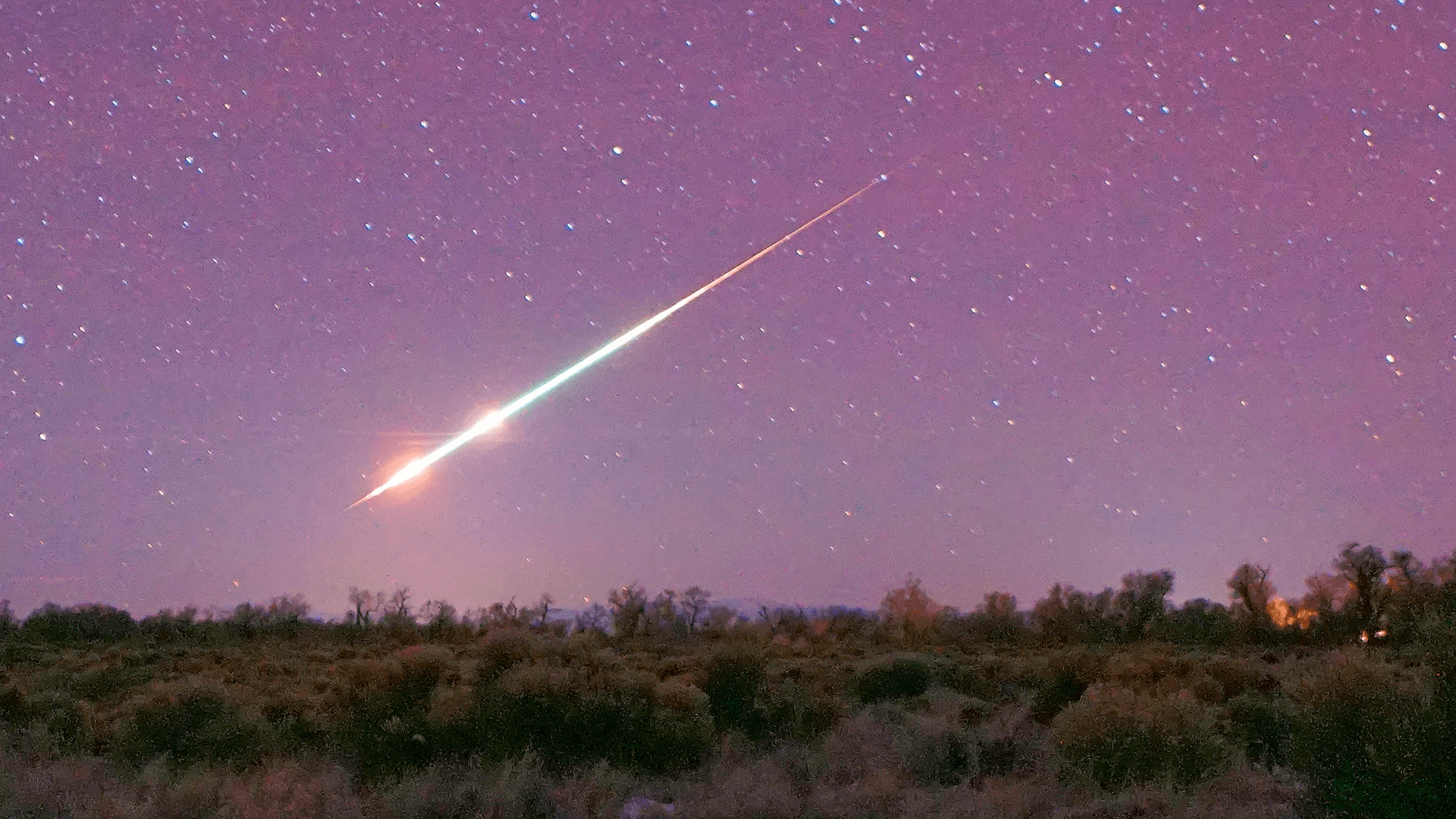 A Geminid meteor in a purple sky