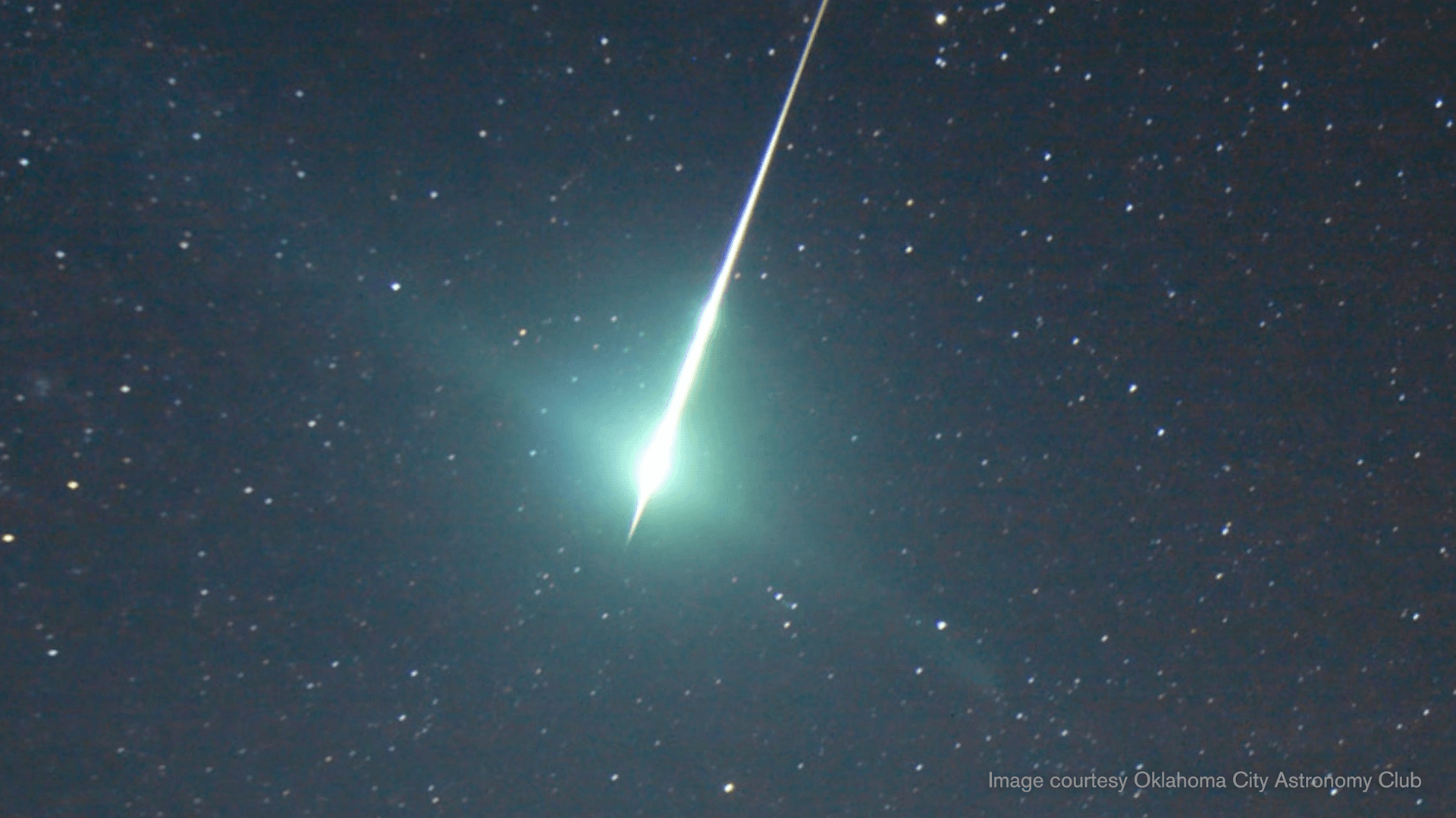 A teal Quadrantid meteor in the night sky
