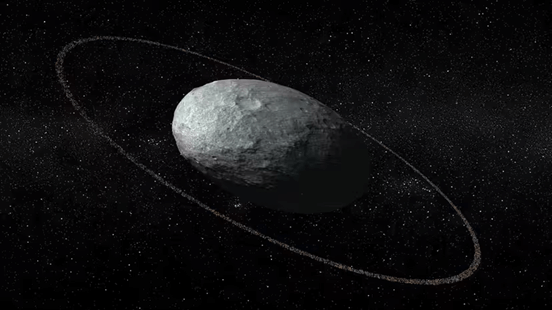 A model of the trans-Neptunian object Haumea, which is classified as a dwarf planet despite being forced into a rugby ball shape by its rapid spin. Credit: J. M. Madiedo/J. L. Ortiz/IAA-CSIC