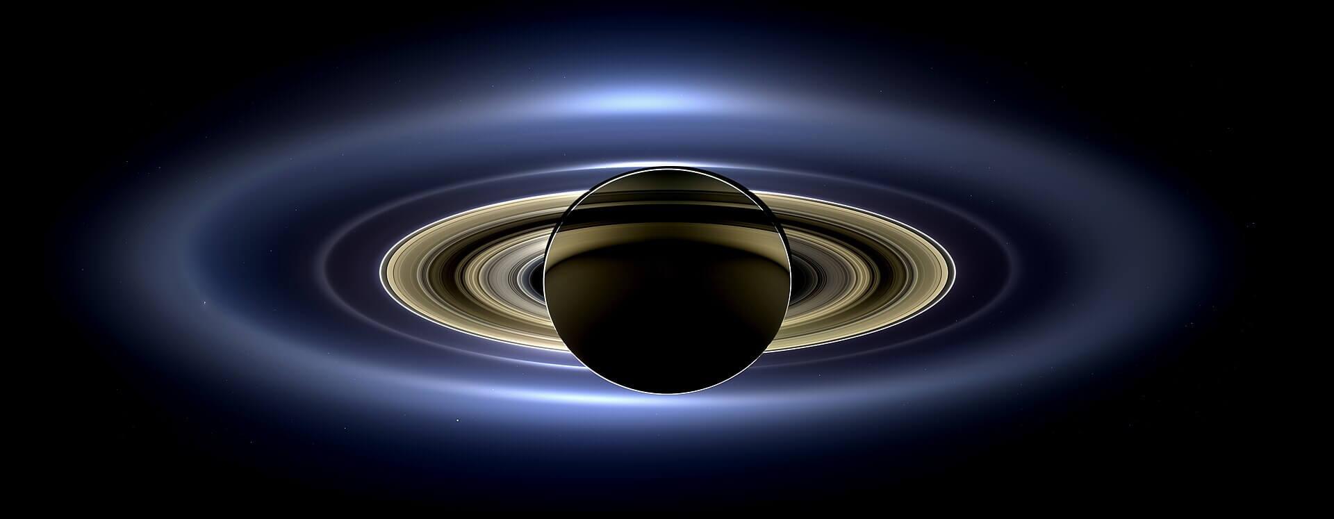 The image known as the The Day the Earth Smiled shows Earth (and the Moon) visible as a bright dot under the rings at lower right. Credit: NASA/JPL/SSI