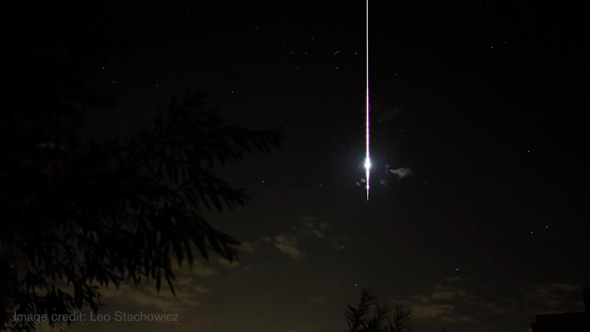 A fireball shoots across a dark sky.