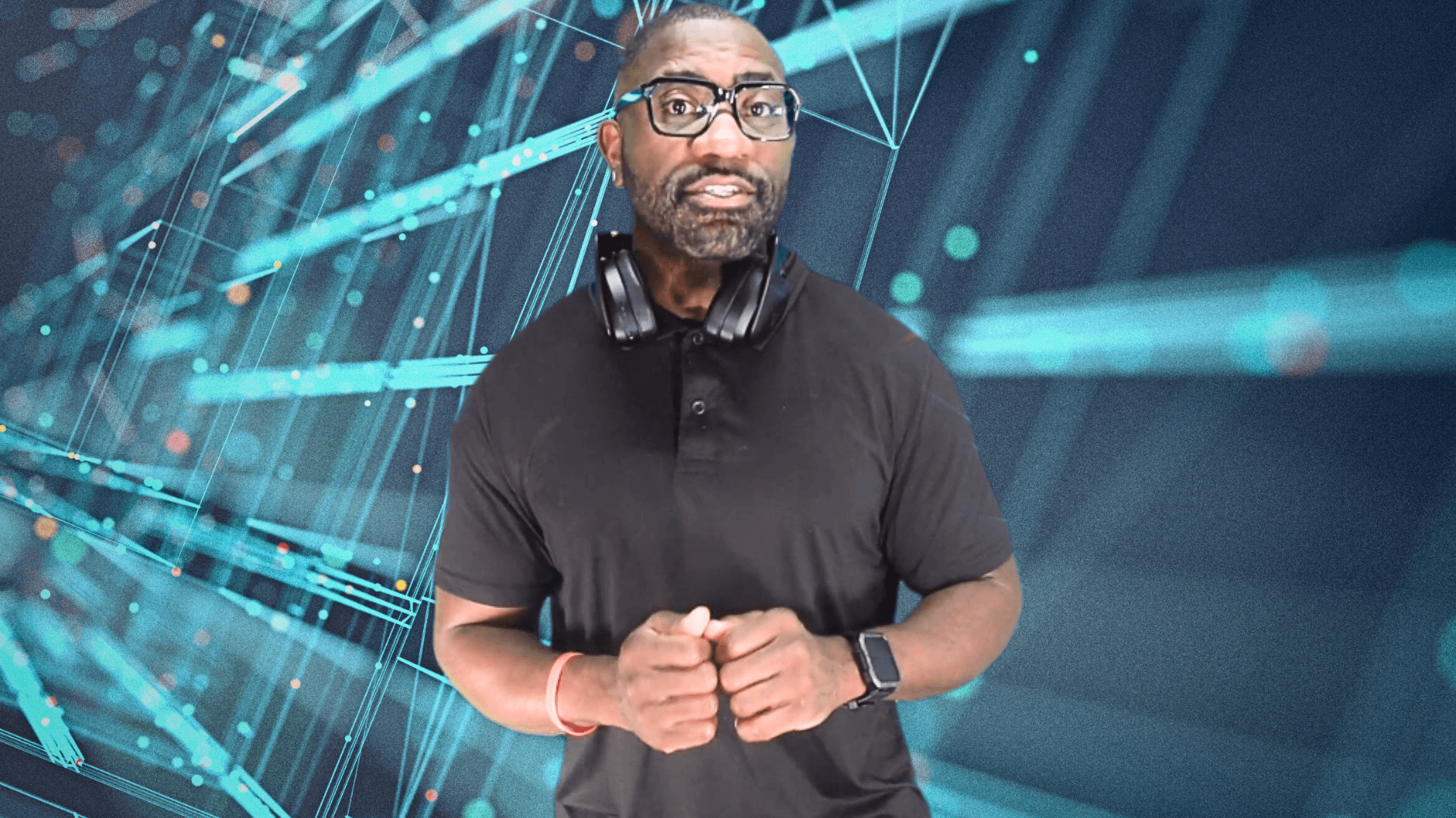 Maynard Okereke in front of a blue and black computer board.