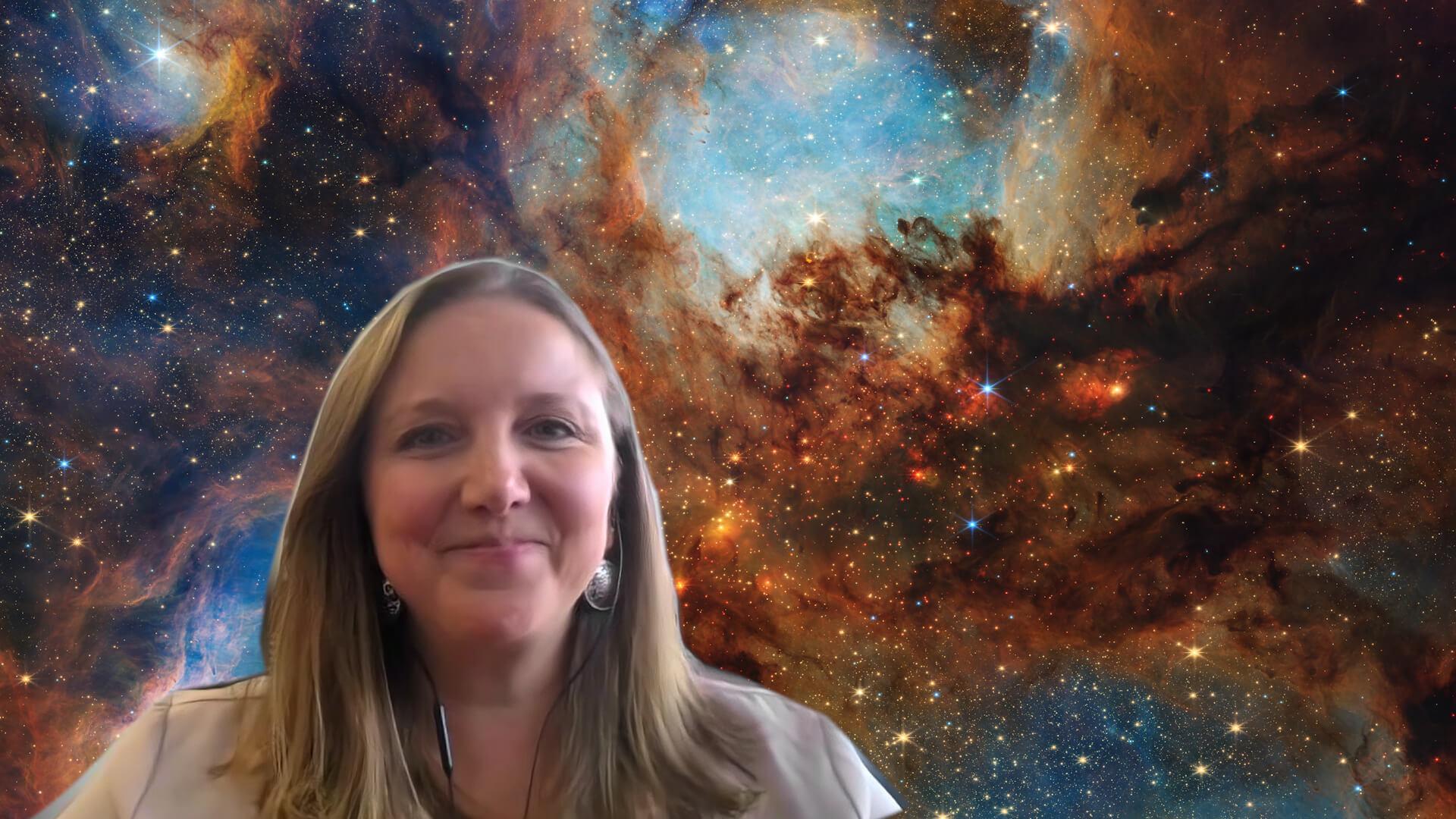 Stefanie Milam in front of a JWST image