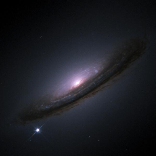 The galaxy in this image is 55 million light years away. In 1994 it experienced a supernova, visible as the bright spot on the lower left. It shows how bright a supernova can get. Credit: NASA/ESA/Hubble Key Project Team/High-Z Supernova Search Team