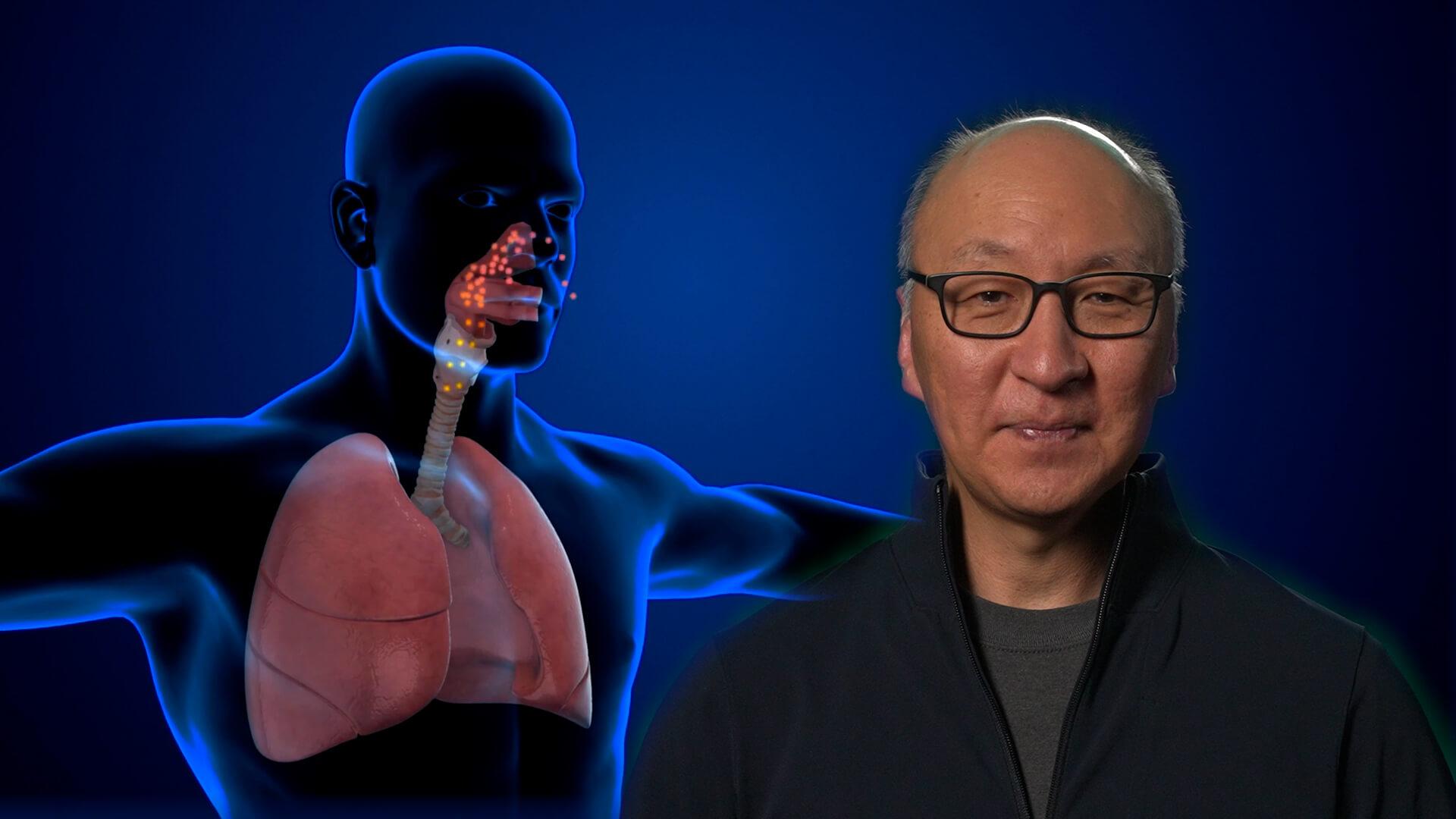 Insoo Hyun in front of a model of the human respiratory system