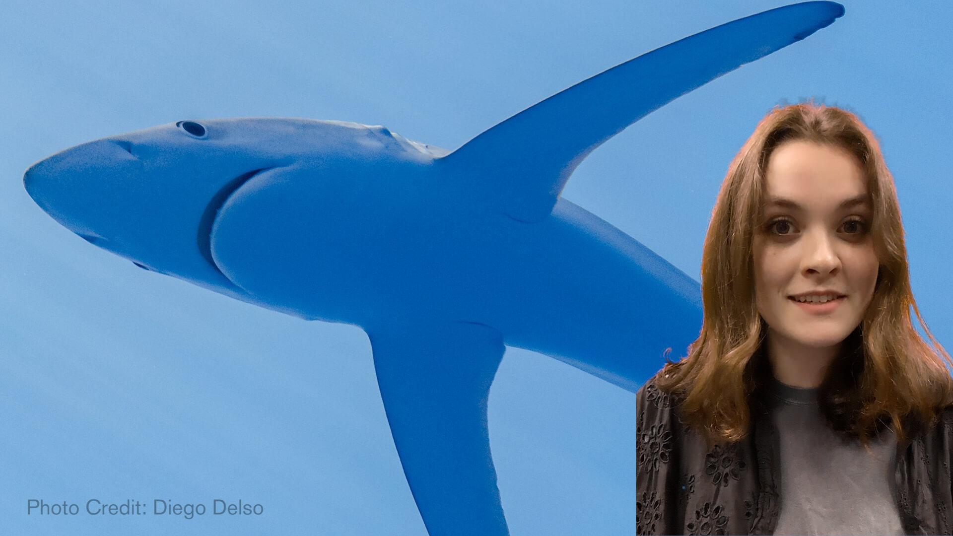 Museum Educator Eva in front of a blue shark
