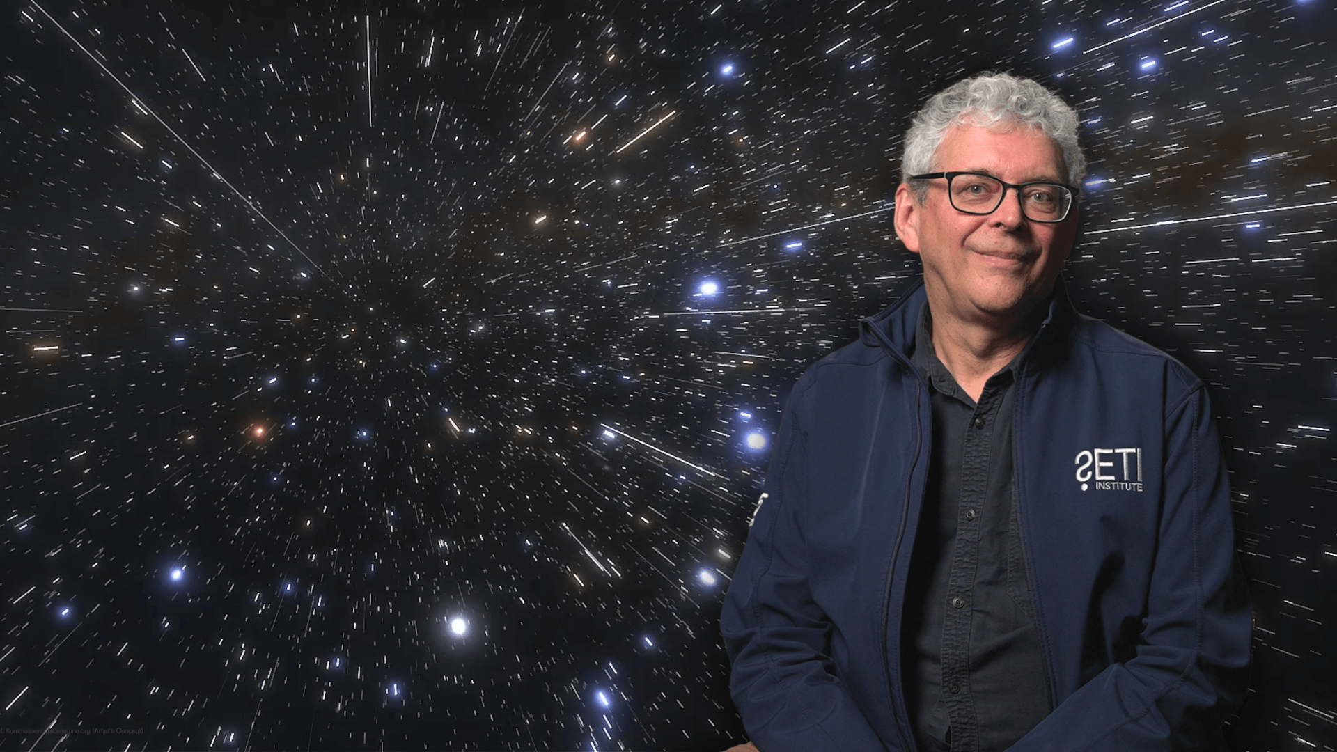Simon Steel in front of a photo of space.