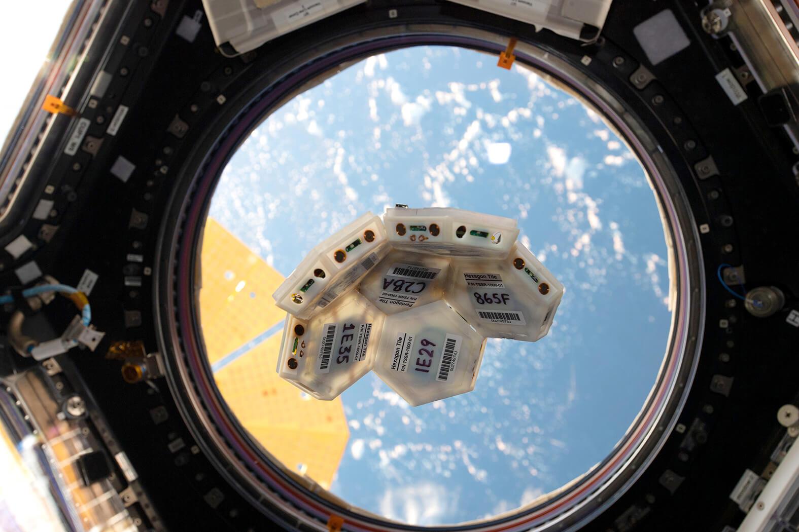 Small versions of TESSERAE tiles being tested in the microgravity of the ISS. Credit: Aurelia Institute