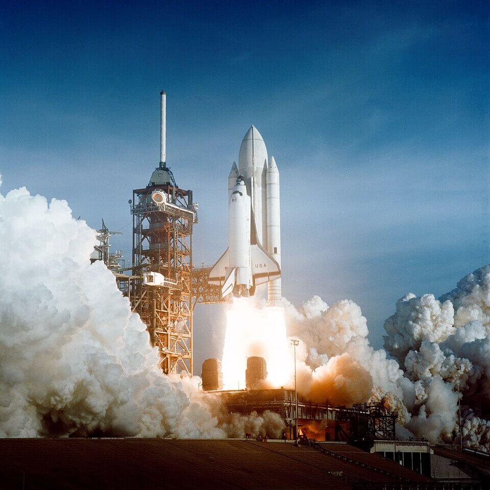 The launch of the first space shuttle mission. Note that at this point the gas tanks were painted white. This was later changed to orange to make them more visibly distinct from the shuttle orbiters during launch. Credit: NASA