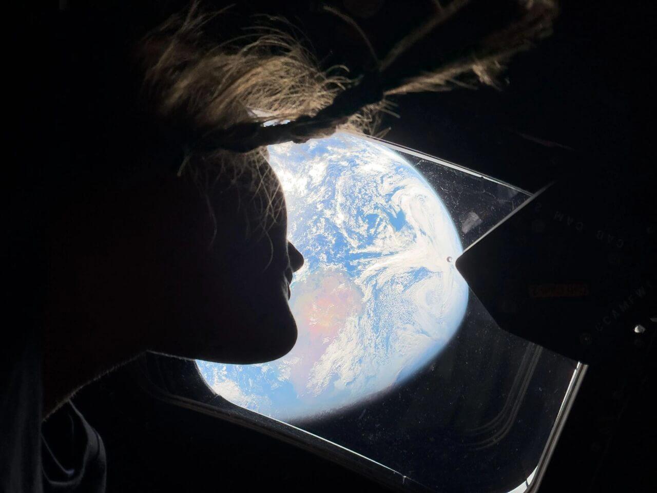 Astronaut Christina Koch looks out of the Orion capsule window towards Earth. Credit: NASA