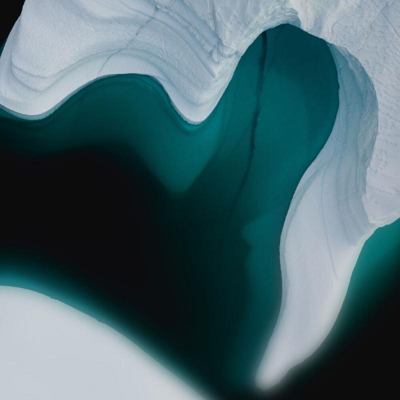 An overhead photo of ice in blue-green water.