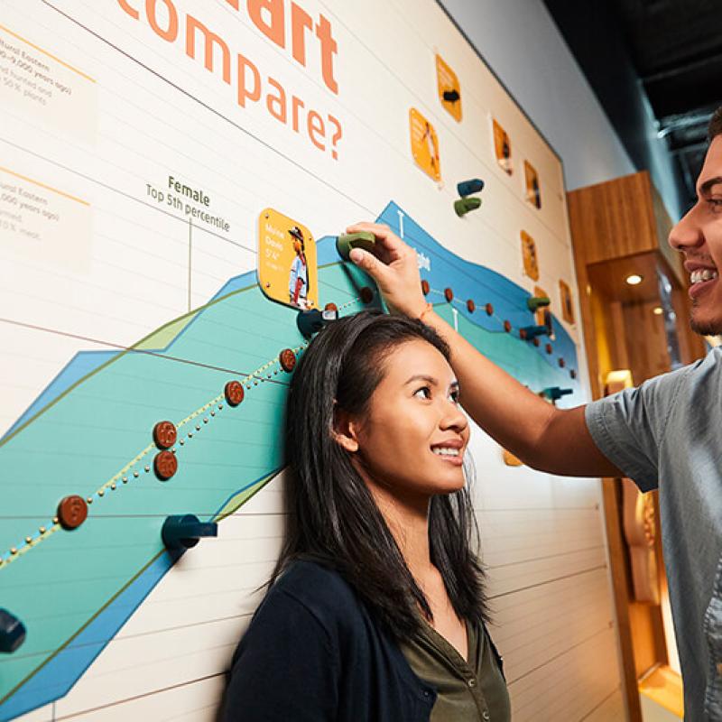 Two young professionals in an exhibit at the Museum of Science.