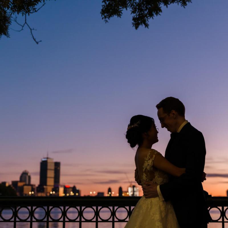 A couple embracing against a sunset.