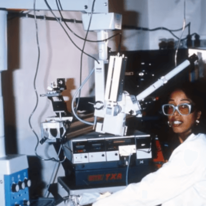 Dr. Patricia Bath sits in an optometry office surrounded by equipment