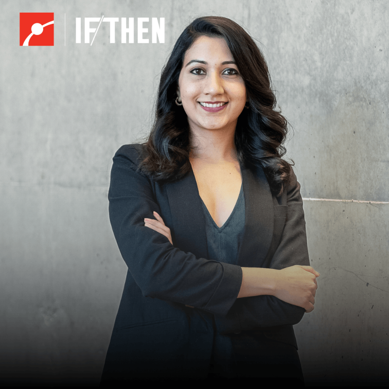 Shyla Raghav smiles at the viewer with arms crossed in a black blazer