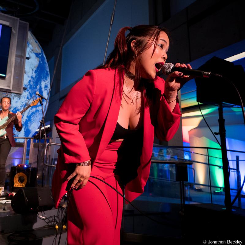 A singer performing on the CS&T stage during a SubSpace event.