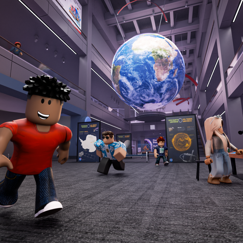 A Roblox character smiles at the viewer while running on the lower level of Blue Wing of the Museum.